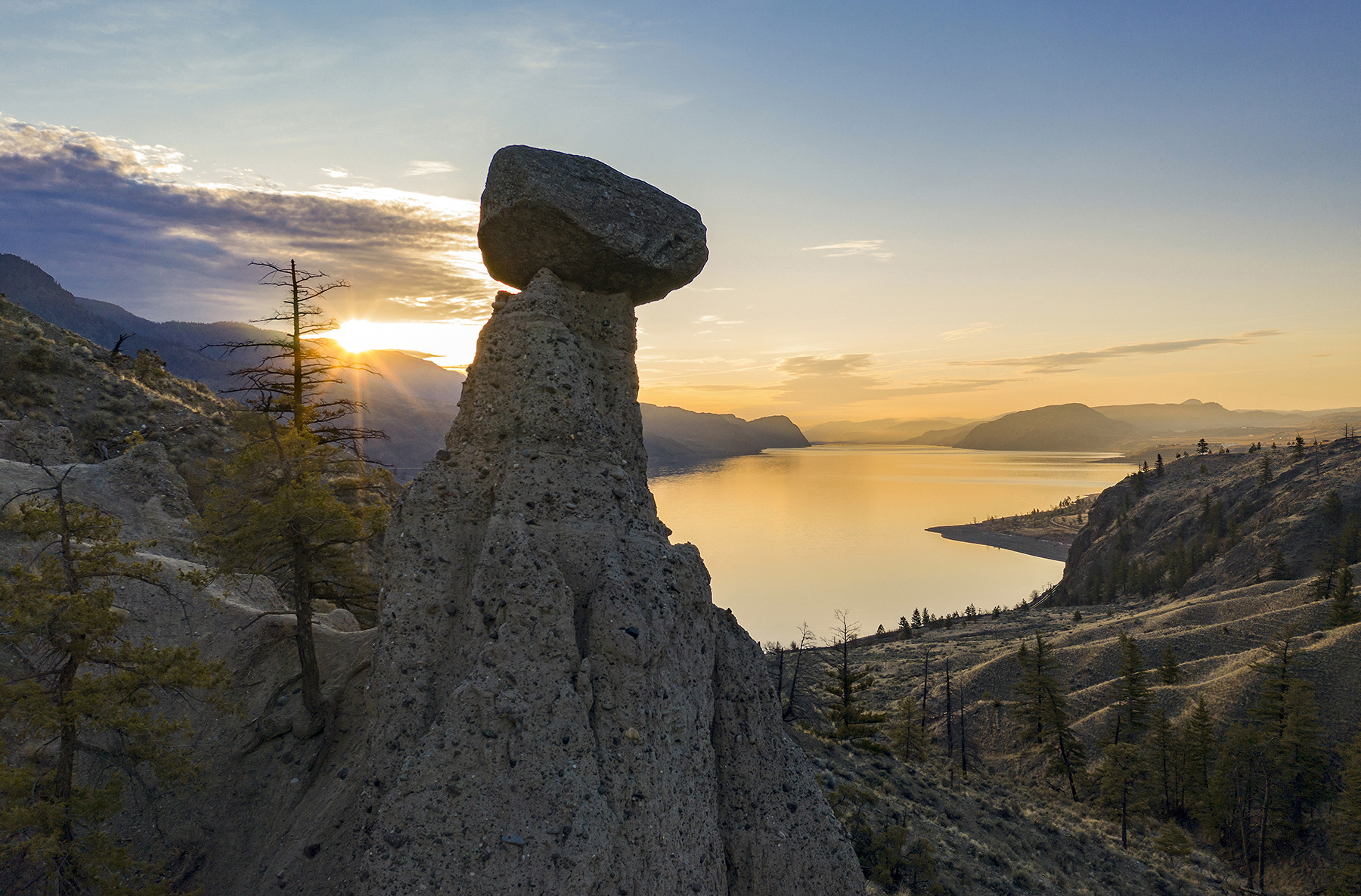 The Balancing Rock hoodoo above Kamloops Lake at sunset